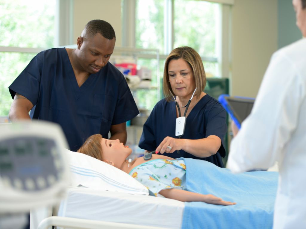 Healthcare team practicing neonatal resuscitation simulation using Elevate Healthcare neonatal simulator, Luna.